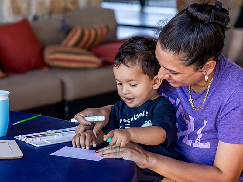 Family enjoying creative activities at Travisso community home.