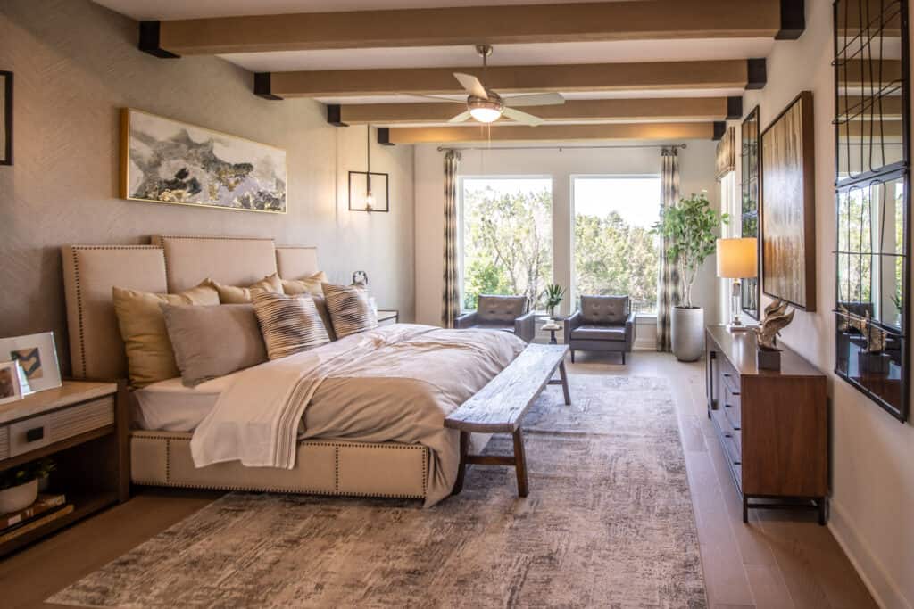 Spacious bedroom at Travisso featuring elegant decor, large windows, and a cozy, inviting atmosphere.