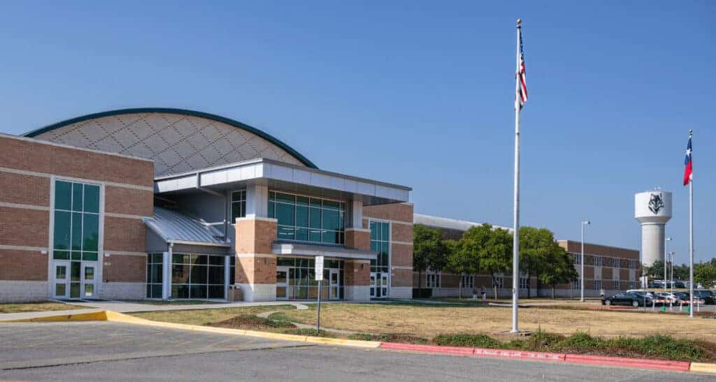 Vandegrift High School in Travisso, Texas, with modern architecture and flagpoles.