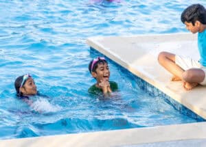 Kids enjoying swimming and playing at the Travisso community pool.