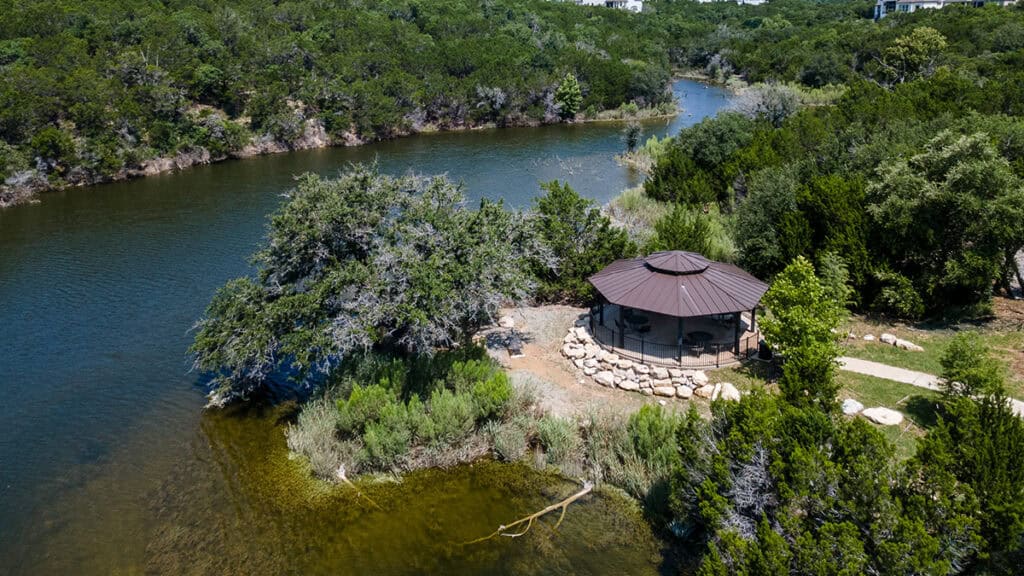 Scenic view of Travisso with river, trees, and gazebo.