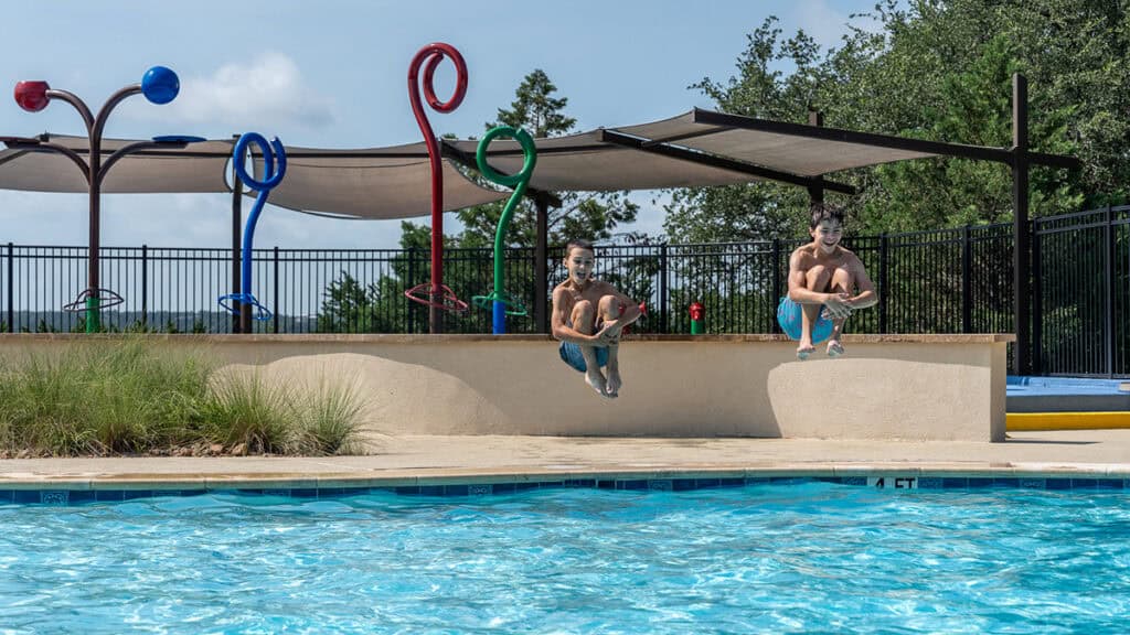 Children enjoying a splash in the community pool at Travisso neighborhood.
