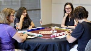 Community members playing a board game at Travisso June event.